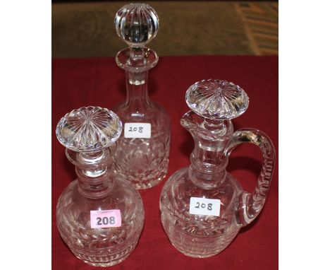 A mallet form cut glass decanter, matching decanter with handle nd another decanter
