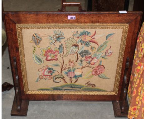 A crewelwork embroidered oak firescreen