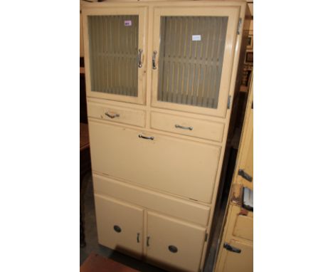 A 1950's painted kitchen cabinet with glazed cupboard over two drawers and fall front with enamel work surface, two cupboard 