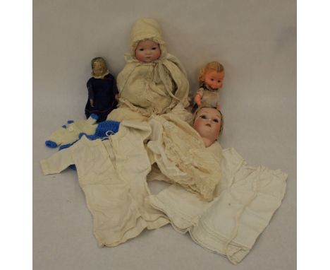 An Armand Marseille baby doll, the bisque head with closed mouth and sleeping eyes, fabric body and limbs the lace clothes co