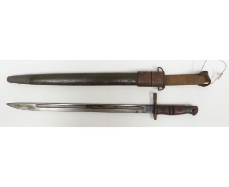 A British military 1917 Remington bayonet and scabbard with wooden handle and leather belt-attachment, 22.5ins long (57cms)