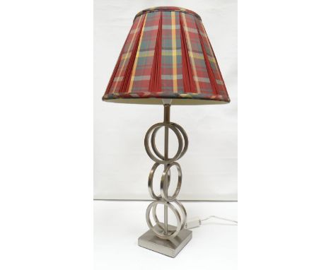 A contemporary chrome table lamp composed of six conjoining rings on a square base
