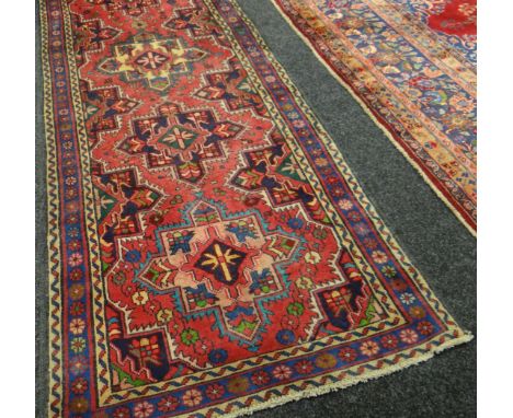 A hand-woven Persian Heriz runner-carpet, 37.5 x 109.5ins (96 x 278cms)