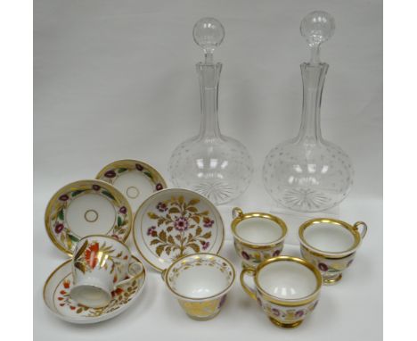 A pair of etched glass onion-shaped decanters; together with various similarly decorated and gilded cups and saucers