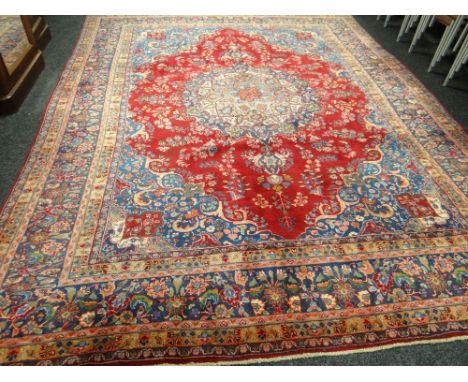 A splendid hand-woven Persian Sarouk carpet with shaped medallion design, 113 x 149ins (286 x 380cms)