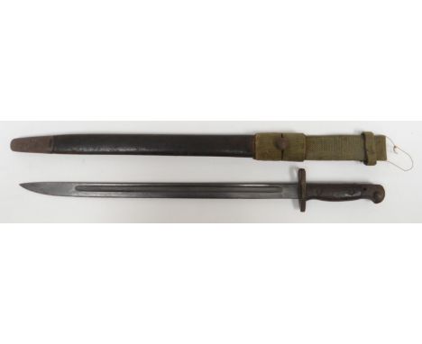 A British military 1907 bayonet and scabbard with wooden handle and canvas belt attachment, 22.5ins long (57cms)