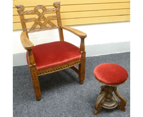 A Welsh Bardic style arm-chair with Celtic carvings and elaborate back, having a pink covered cushion seat