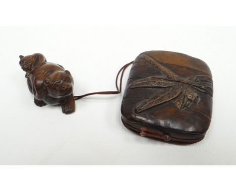 A Meiji period four-section inro carved with dragon-fly in relief and attached by cord to a carved netsuke of bear and cub