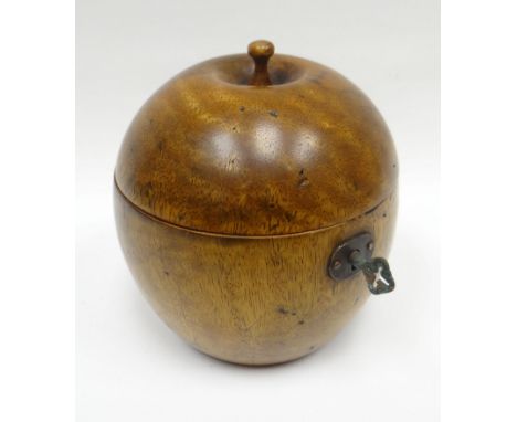 A reproduction wood-turned fruit-form tea-caddy with hinged lid and silvered interior, 5ins high (12cms)