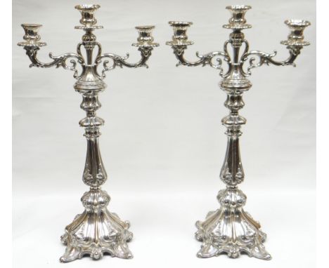 A pair of Continental (possibly Dutch) silver three branch candelabra with removable branches to form candlestick holders, in