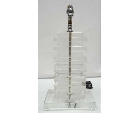 A contemporary clear perspex and chrome table lamp of cubist form and raised on four ball-feet, 17.5ins high excl. shade (44c