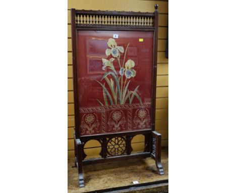 AESTHETIC-MOVEMENT FIRE SCREEN with carved bobbins and open work, the panel with floral upholstery and the reverse with inter