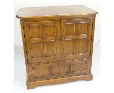 ERCOL TV CABINET with base drawer and carved panel design, 92cms wide