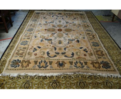 MAINLY GREEN &amp; GOLD GROUND PERSIAN RUG with centre decoration and contrasting border, 341 x 251cms (some discolouration o