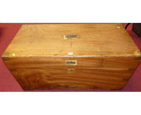 An early 20th century Eastern camphorwood and brass bound travelling trunk, having iron end carry handles, width 98cm