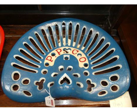 A pierced and cast iron tractor seat titled P.P. Co., painted in blue, red &amp; white, 34 x 42cm