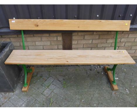 A green painted cast iron ended and pine three seater waiting room bench, length 150cm