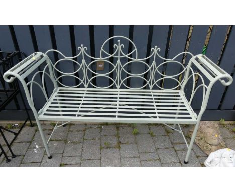 A contemporary pale green painted wrought iron two seater folding garden bench, having scroll arms and stapwork seat, width 1