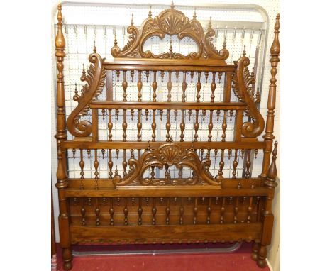 A Spanish elm double bedstead, the head and footboard with raised floral stylised and further ring turned decoration with sid