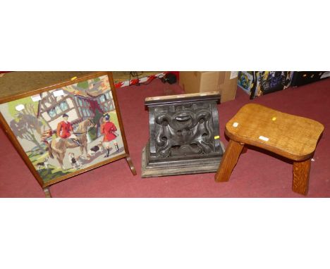 An ebonised and relief carved oak wall shelf in the form of a corbel, together with a milking stool and  a fire screen (3)