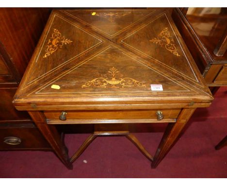 An Edwardian rosewood floral satinwood and further ivory strung envelope card table, having green leather interior, single fr