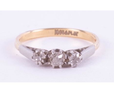 An 18ct and platinum diamond three stone ring, 2.39g.