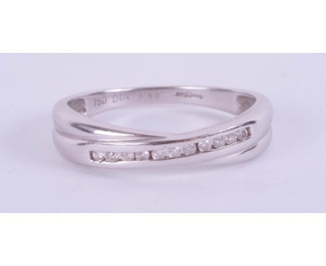 An 18ct white gold diamond set crossover ring size O.