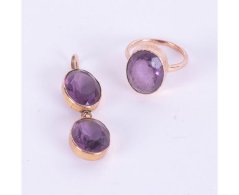 An amethyst and yellow metal ring and a double amethyst pendant for a necklace.