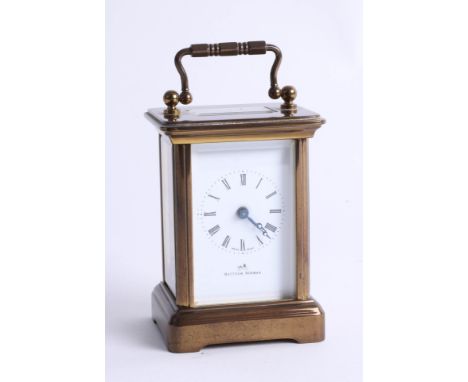 A Matthew Norman miniature brass carriage clock with winding key, Roman numerals, 11 jewel, height 8cm.