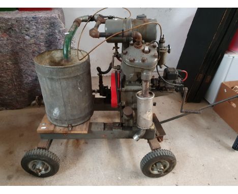 A JAP water cooled stationary V Twin engine, serial number poor M?D/G/ 66224, mounted on a four-wheel carriage. &nbsp;£40 + V