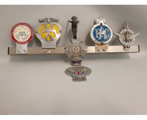 A badge bar mounted with a diving lady car mascot, stamped R/D, AEL, together with six badges and a Castella cigar card set.
