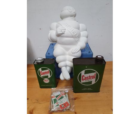 Two Castrol Motor oil cans, apparently unused, various Castrol stickers and a reproduction seated Michelin Man.