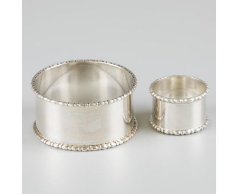 The napkin ring without engraving, both with identical rim decoration. The Netherlands, Voorschoten, Zilverfabriek Voorschote