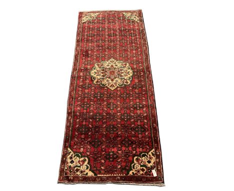 Persian red ground runner rug, central pale floral medallion and corners, floral and shaped fieldDimensions: Length/Width:&nb