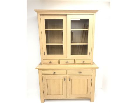 Marks &amp; Spencer's solid light oak dresser, raised back with two sliding display doors above three short and two drawers, 