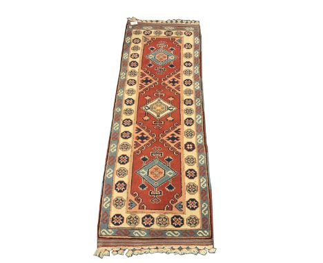Turkish style runner rug, triple medallion surrounded by red field, inner floral boarder and patterned outer Dimensions: Leng
