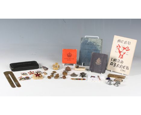 A small group of military-related items, including a Birmingham silver pillbox with RAF badge, a brass cigarette paper holder