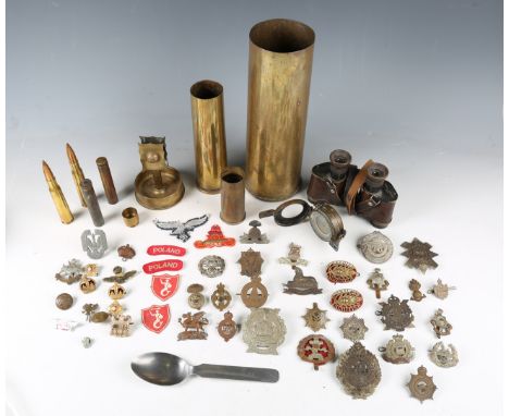 A small collection of early to mid-20th century military-related items, including various brass shell cases, one engraved 'Re