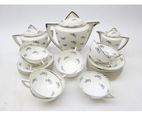 Art Deco Limoges Unique tea service, stylized handles, silvered borders on rose sprig printed ground comprising teapot, milk 