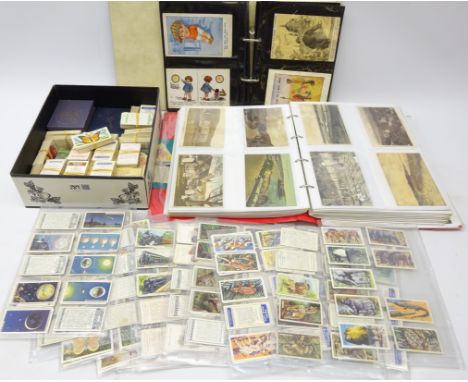 Collection of postcards including topographical, comical, ethnic etc in two ring binder albums, various cigarette cards inclu