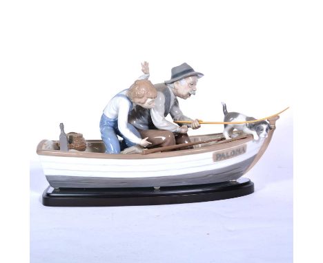 A large Lladro group, 'Fishing with Gramps'/ 'Paloma', model 5215, on wooden plinth, modelled by Jose Puche, length 39cm, in 