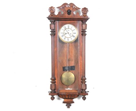 A 19th walnut Vienna type wall clock, walnut case, enamelled dial, twin weight movement striking on a gong, 115cm.Condition r