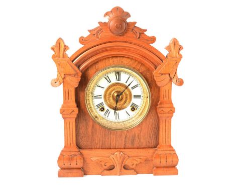 An Ansonia oak cased mantel clock, with strike, with pendulum and key, 38cm.