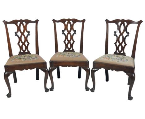 A set of six George II mahogany dining chairs, each with an eared top rail and pierced vase and foliate wrapped splats, later