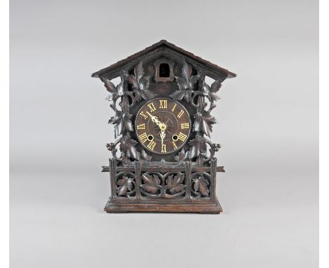 A Black Forest style stained pine case cuckoo clock, late 19 th century, the 6” dial with ivory and Roman numerals and hands 