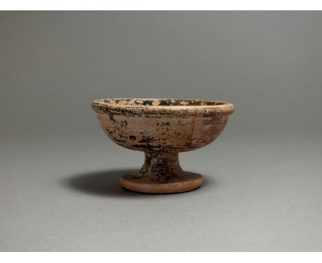 South Italian, Apulian, 4th century BC, ceramic stemmed black glazed cup, flat rim with rounded body and stem base