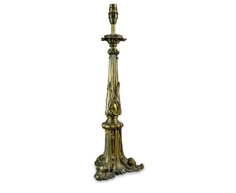 A French gilt brass table lamp, 19th century, of leaf wrapped tapering columnar form on three shell feet. 45cm high