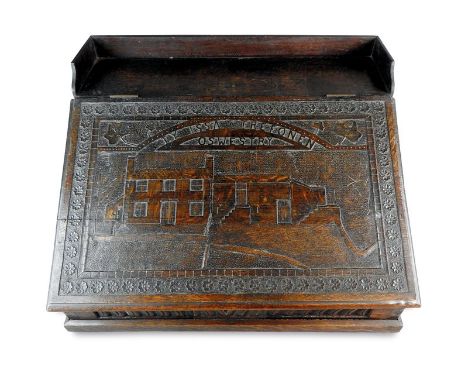 An oak clerks desk, 19th century, the top with low gallery back with a carved fall front inscribed in Ty Issa Trefonen Oswest