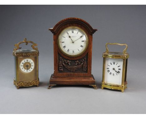 Three early 20th century French timepieces. Two French timepiece carriage clocks and an oak mantel clock, each has an 8-day g