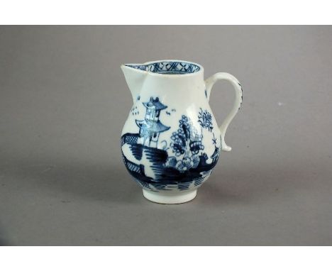 An English blue and white sparrow-beak jug, perhaps Liverpool,painted with a Cannonball style pattern, a fenced building and 